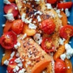 chicken, tomatoes, feta and apricots in a casserole dish.