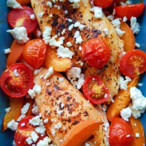 chicken, tomatoes, feta and apricots in a casserole dish.