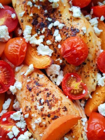 chicken, tomatoes, feta and apricots in a casserole dish.