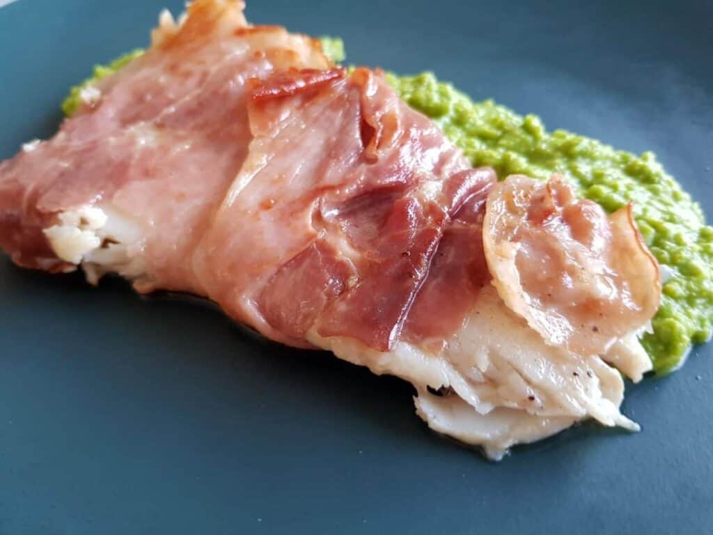 Cod wrapped in prosciutto with peas Hint of Healthy