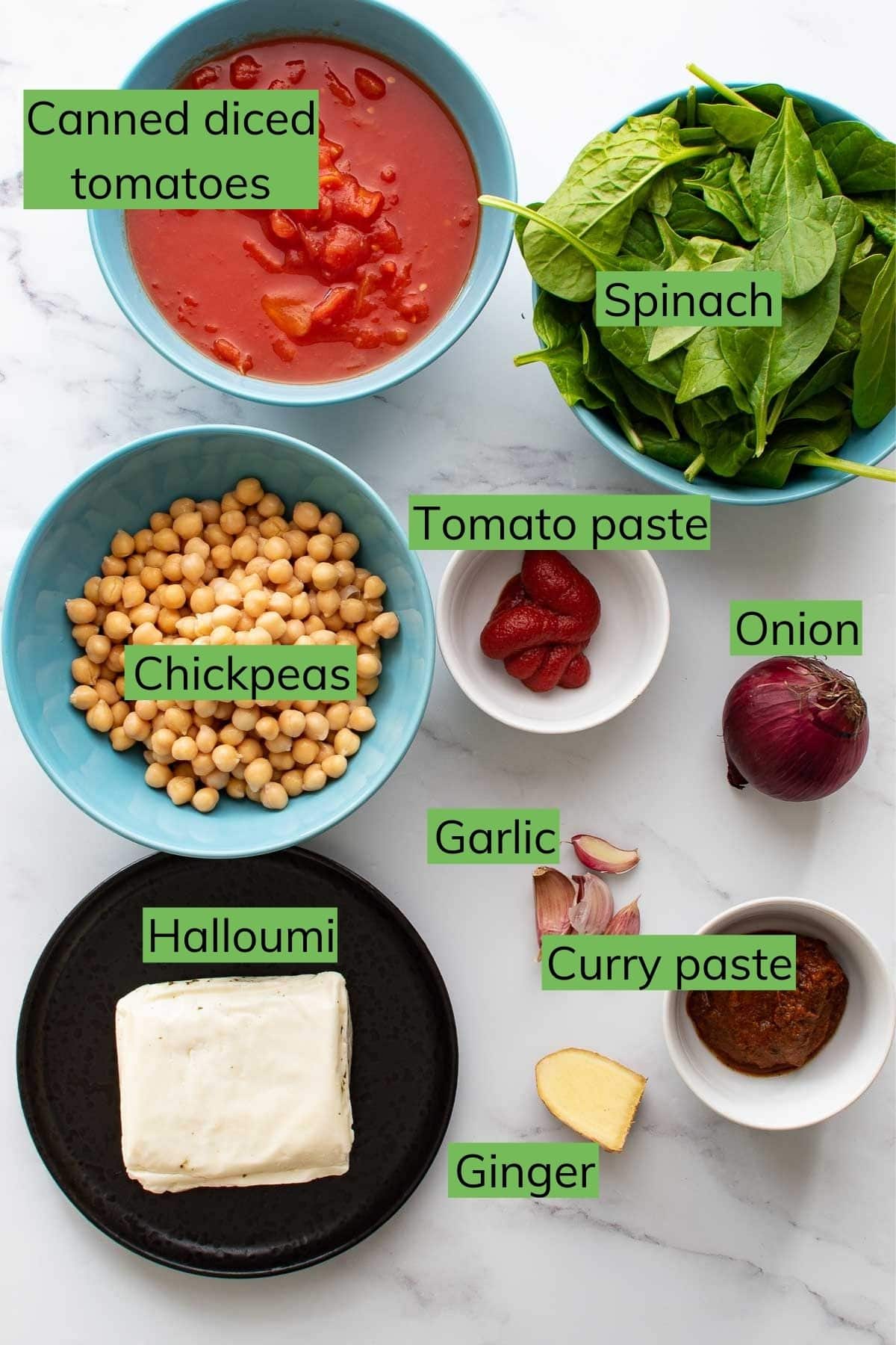 The ingredients needed to make Chickpea and Halloumi Curry laid out on a table.