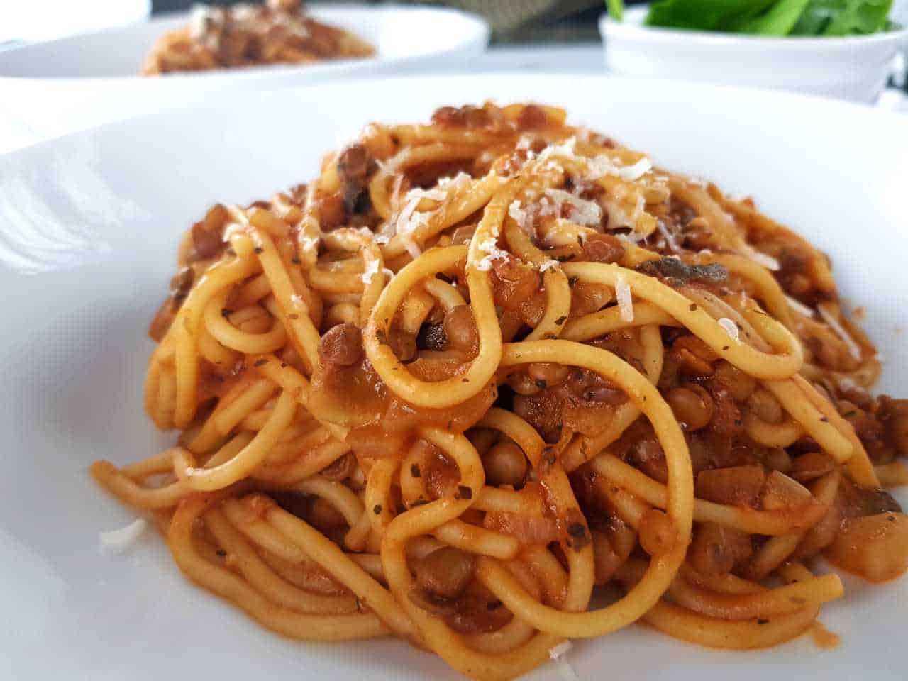 Lentil and mushroom bolognese on a white plate.