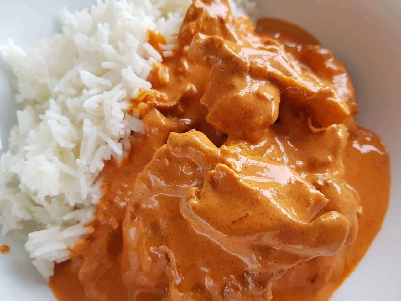 Paprika chicken on a plate with rice.