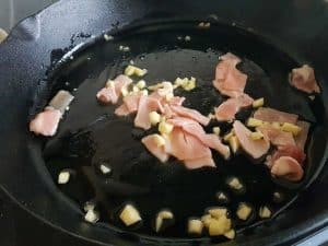 bacon and garlic in frying pan