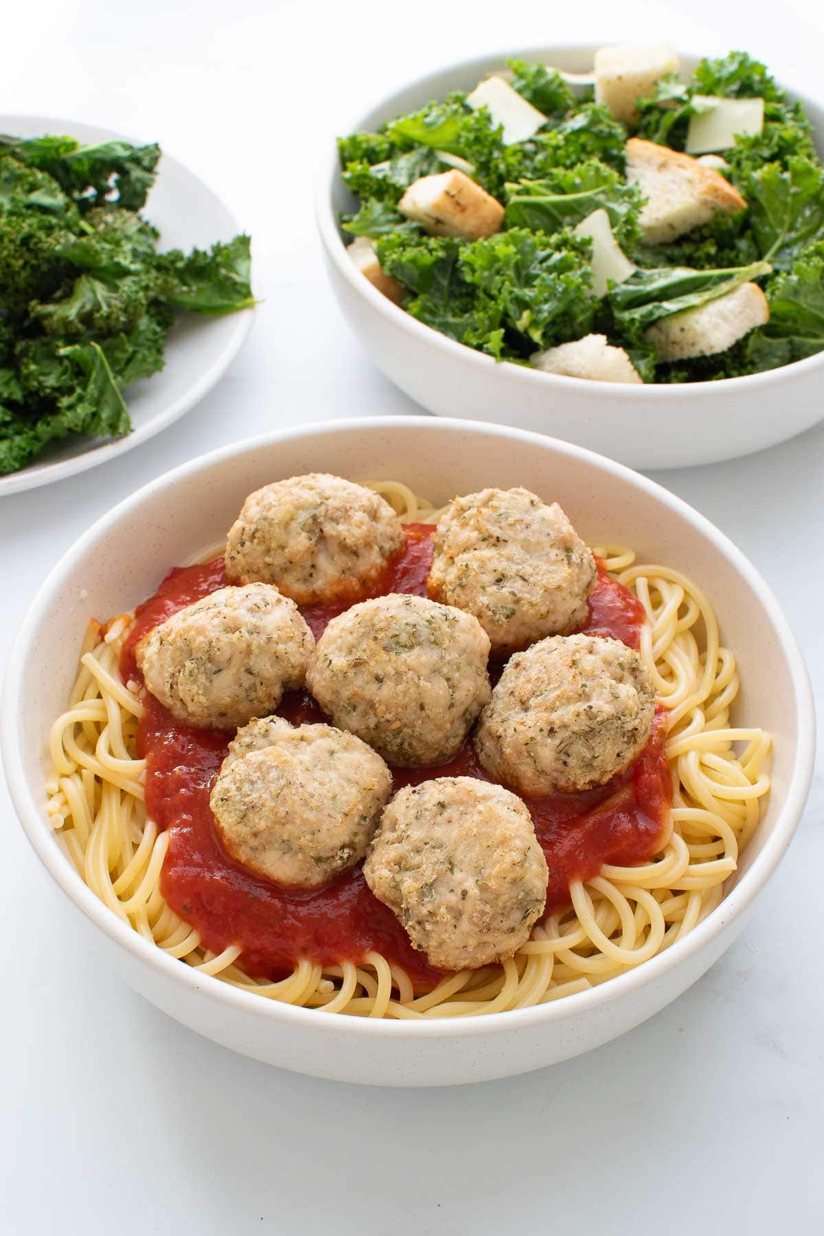 Baked Turkey Meatballs in a bowl with spaghetti and pasta sauce.