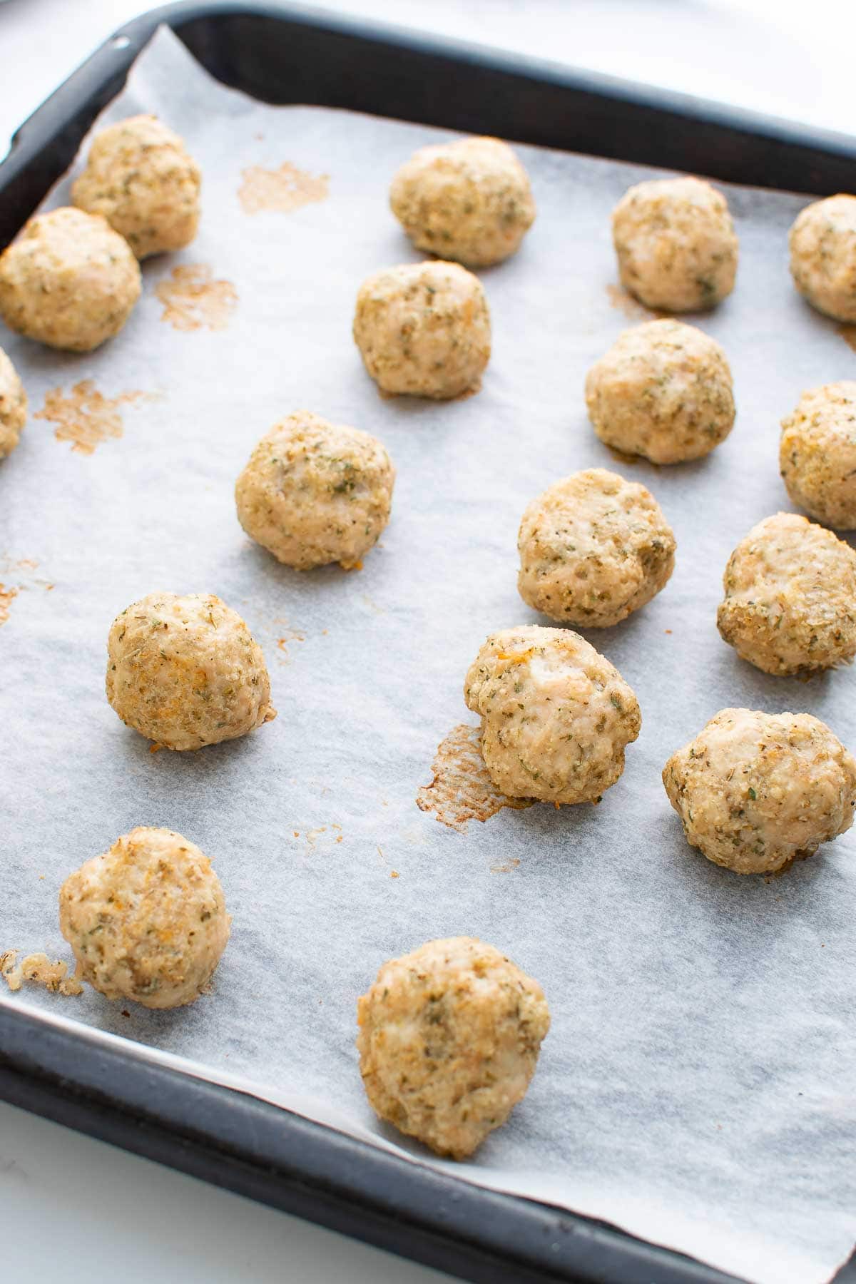 Turkey meatballs on a baking sheet.