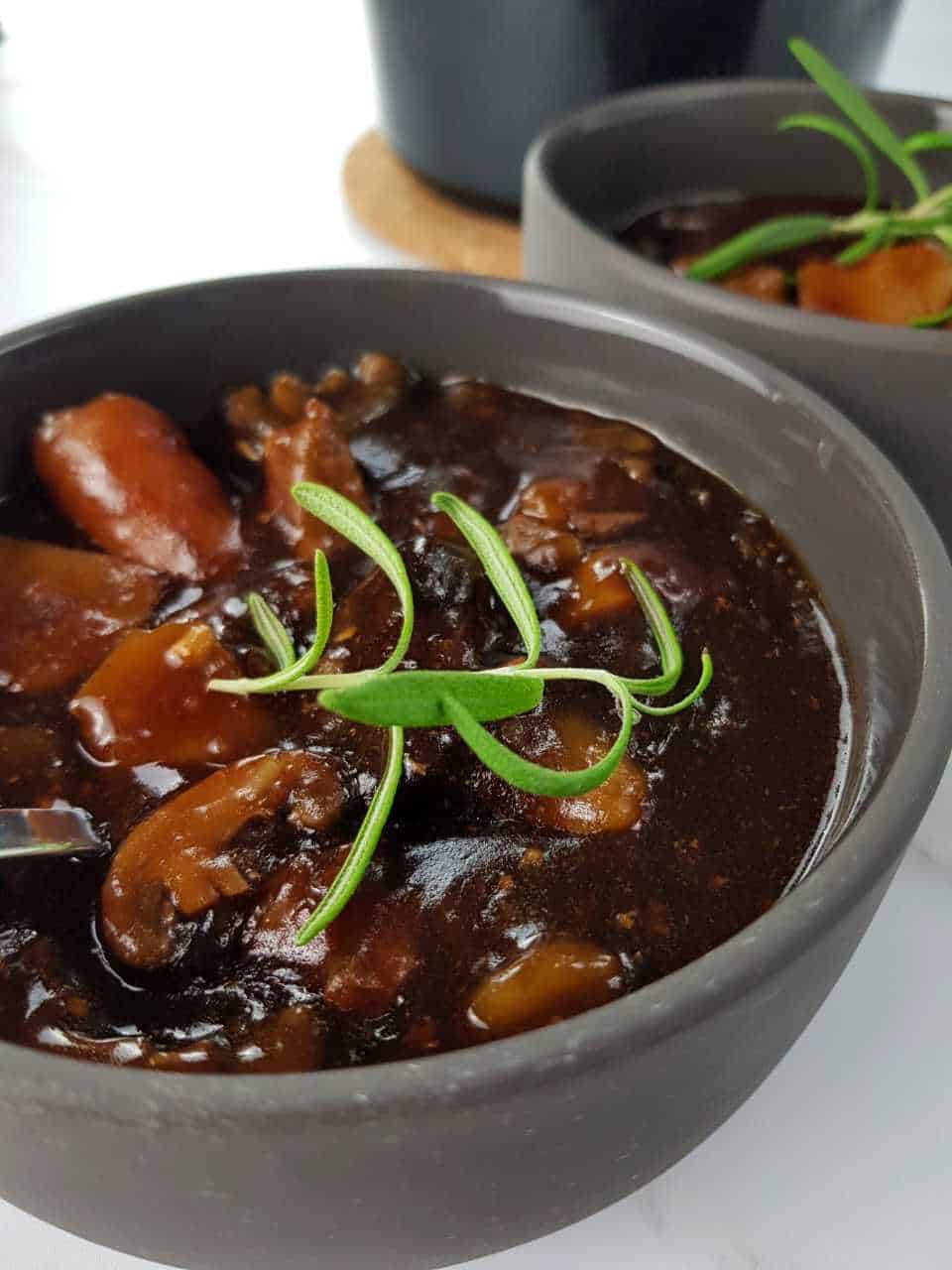 Beef and ale stew in gray bowls.