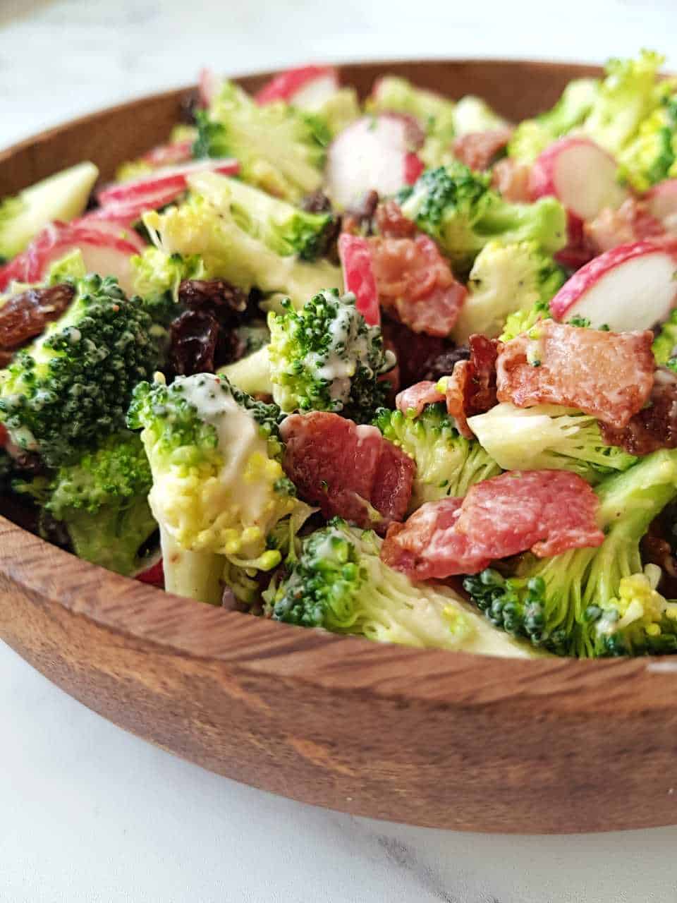 Broccoli salad in a wooden bowl.