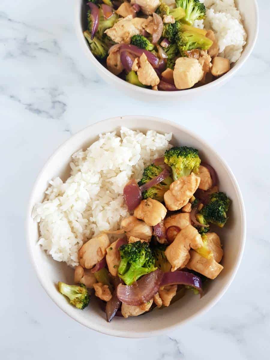 Chicken broccoli stir fry in bowls with rice.