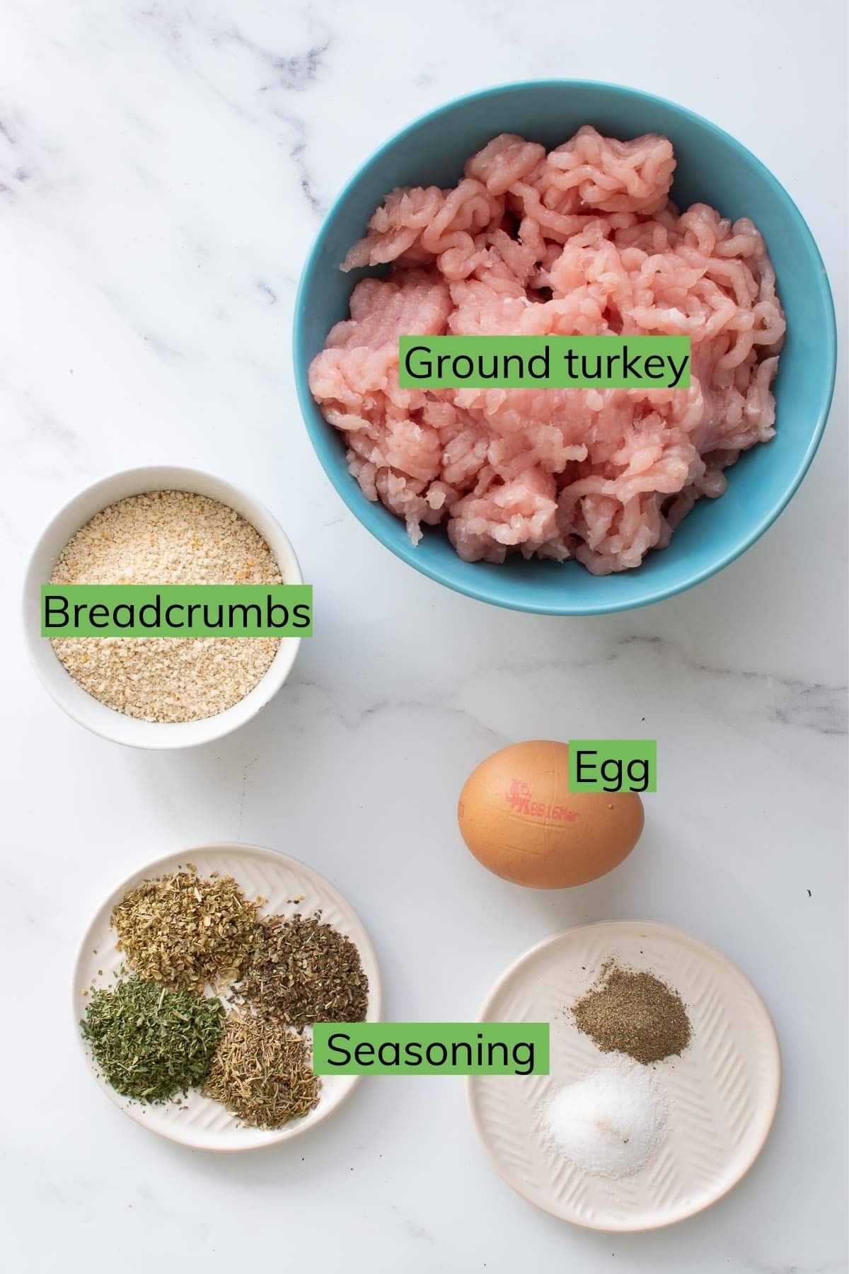 Ingredients needed to make Baked Turkey Meatballs laid out on a table.