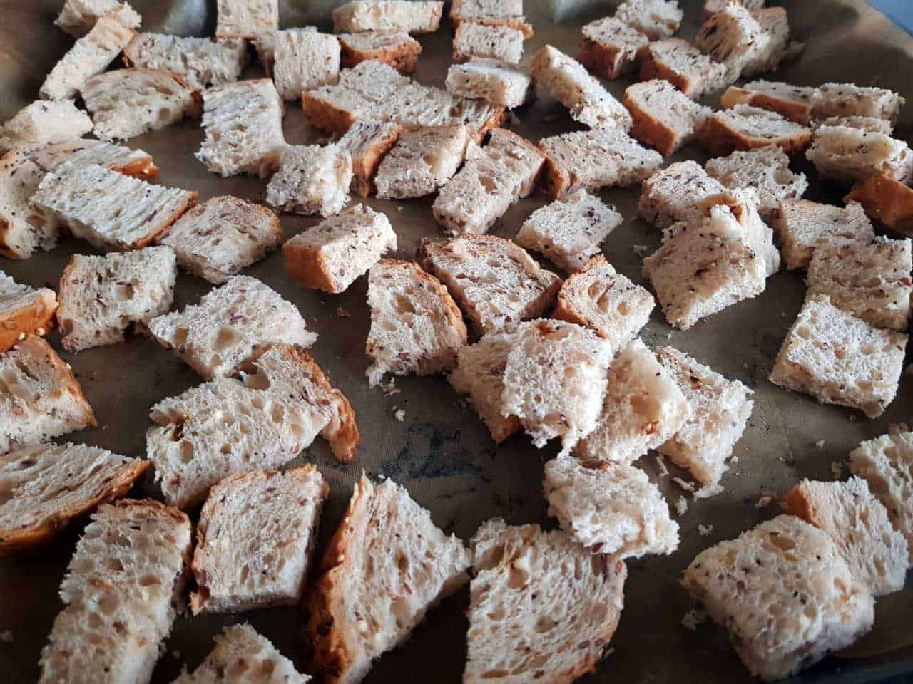 Pieces of bread on a baking tray.