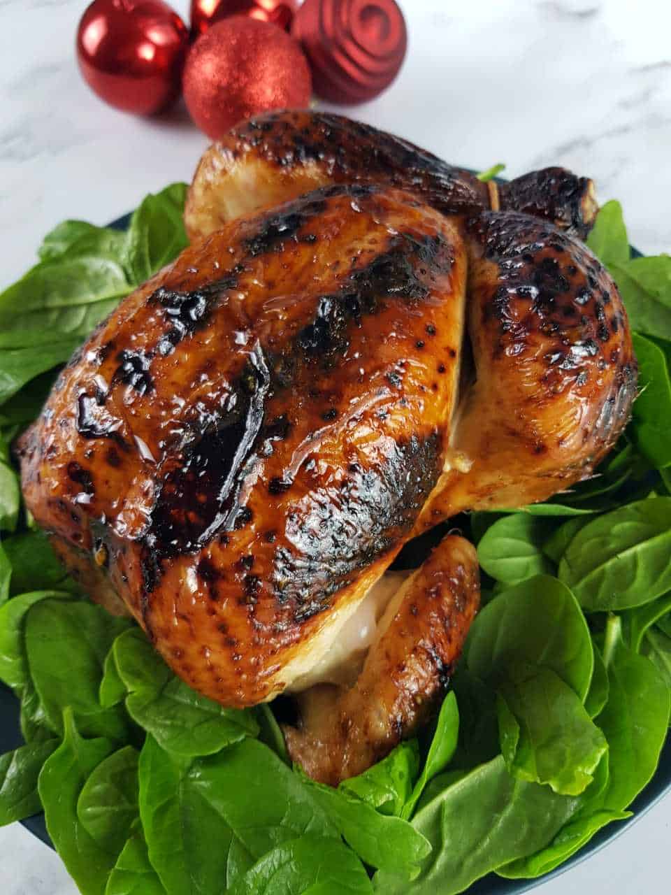 Roast chicken with honey on a bed of spinach.