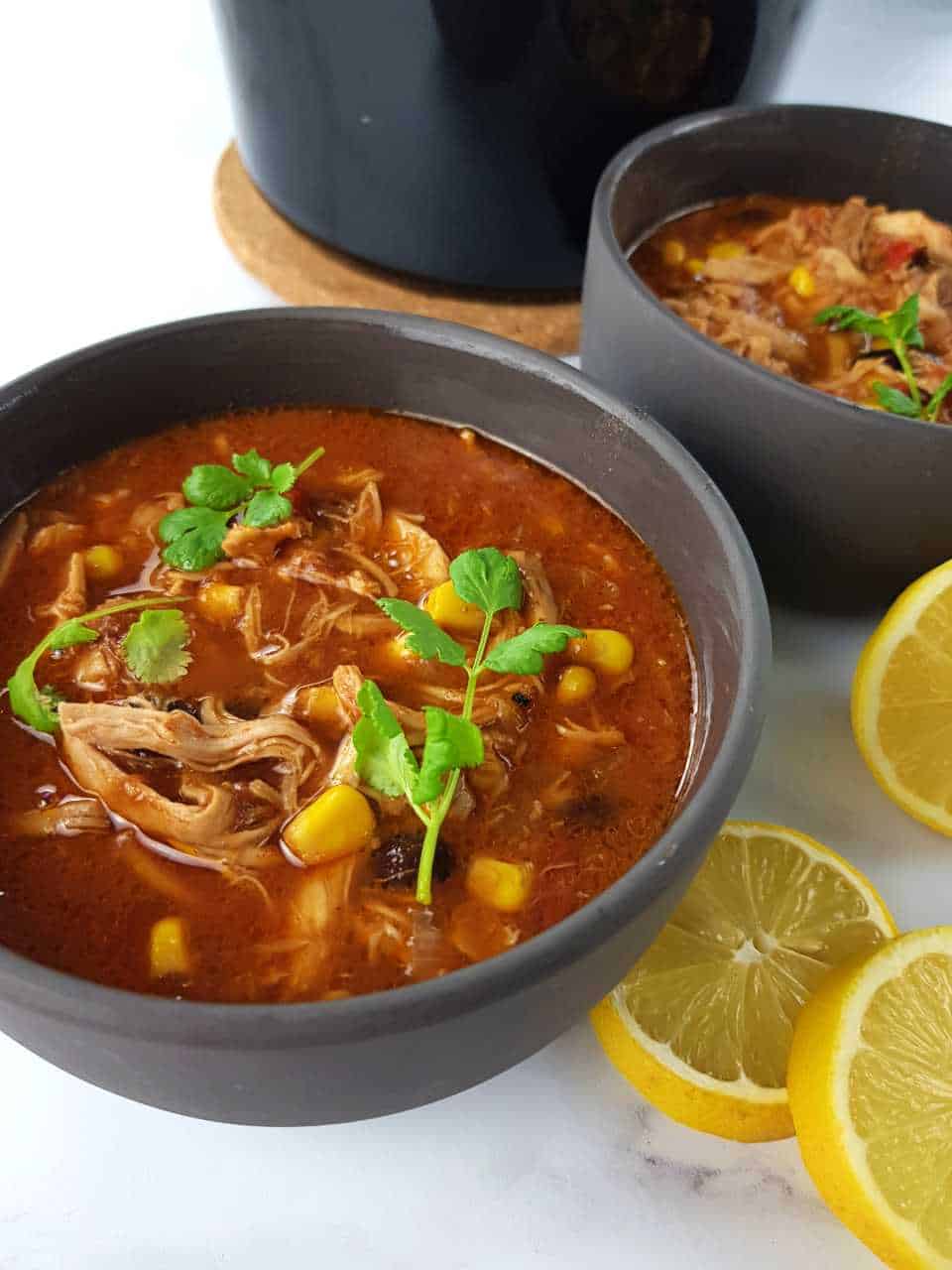 Slow cooker chicken taco soup in gray bowls.