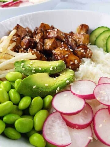 Teriyaki tofu bowl on a marble table.