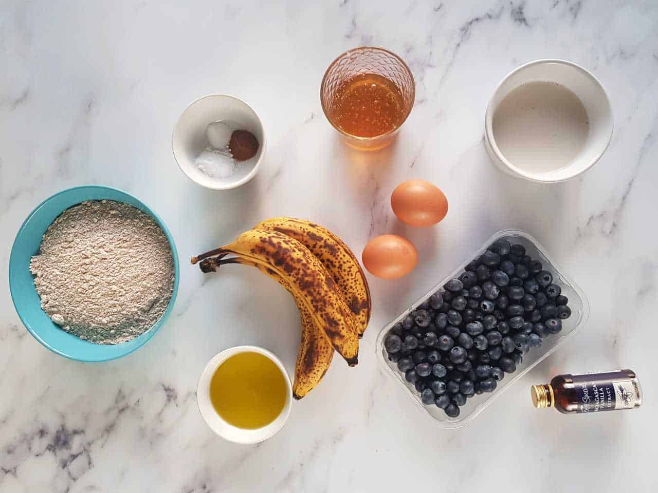 Banana bread ingredients on a marble table.