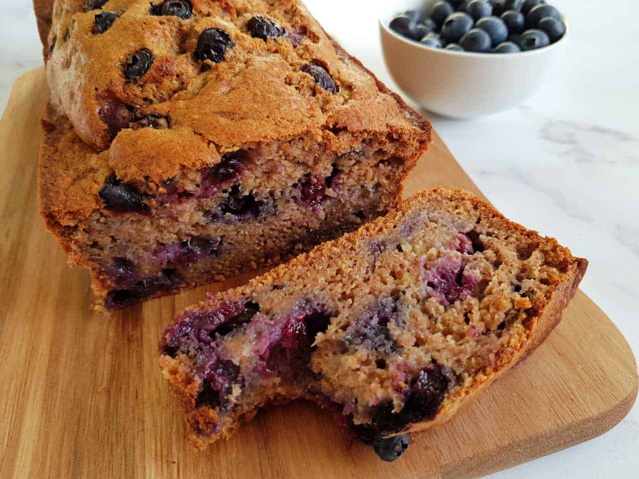 Blueberry & banana bread on a wooden chopping board.