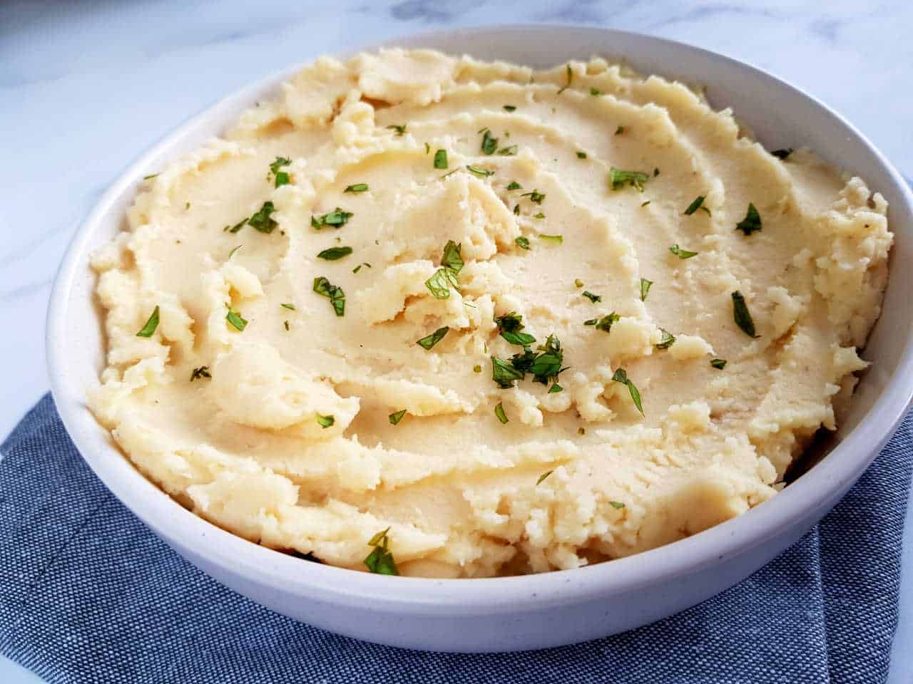 Creamy mashed potatoes in a white bowl.