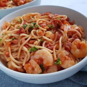 spaghetti, prawns and chorizo in a bowl.