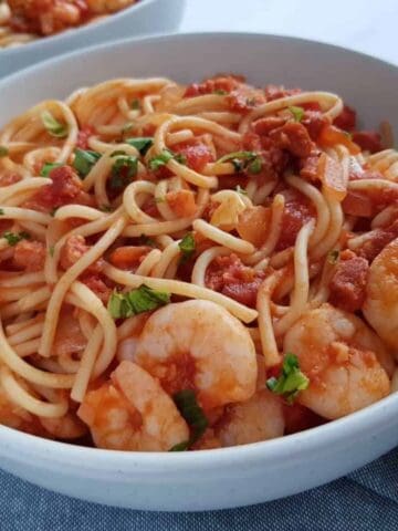 spaghetti, prawns and chorizo in a bowl.