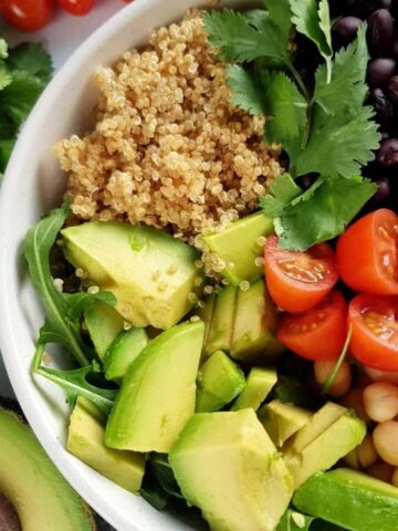 a bowl of mixed quinoa avocado salad.