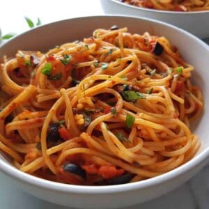 spaghetti alla puttanesca in a bowl.