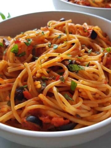 spaghetti alla puttanesca in a bowl.