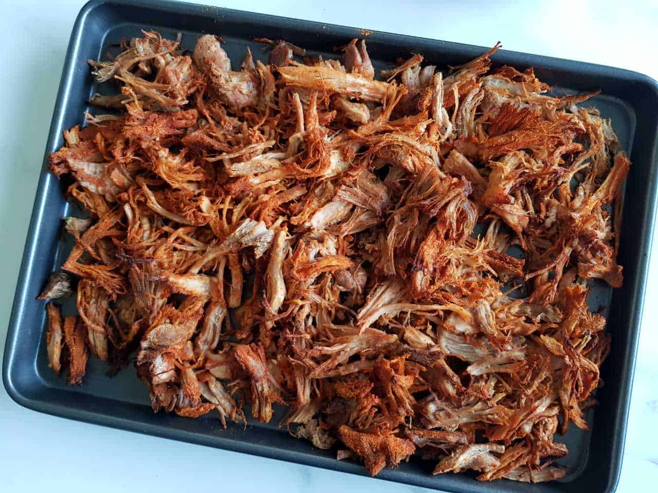 Taco pulled pork on a baking tray.