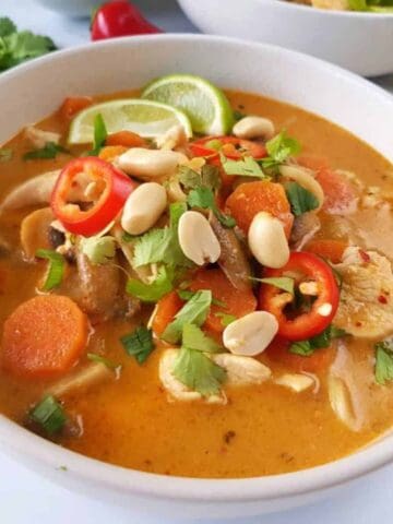 chicken noodle soup with thai flavors in a bowl.