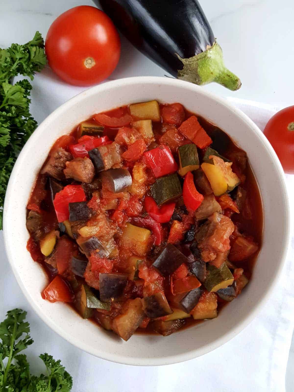 Crockpot ratatouille on a white table.