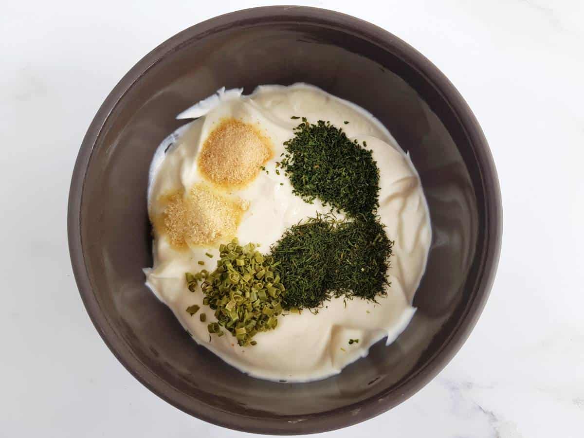 Greek yogurt and herbs in a bowl.