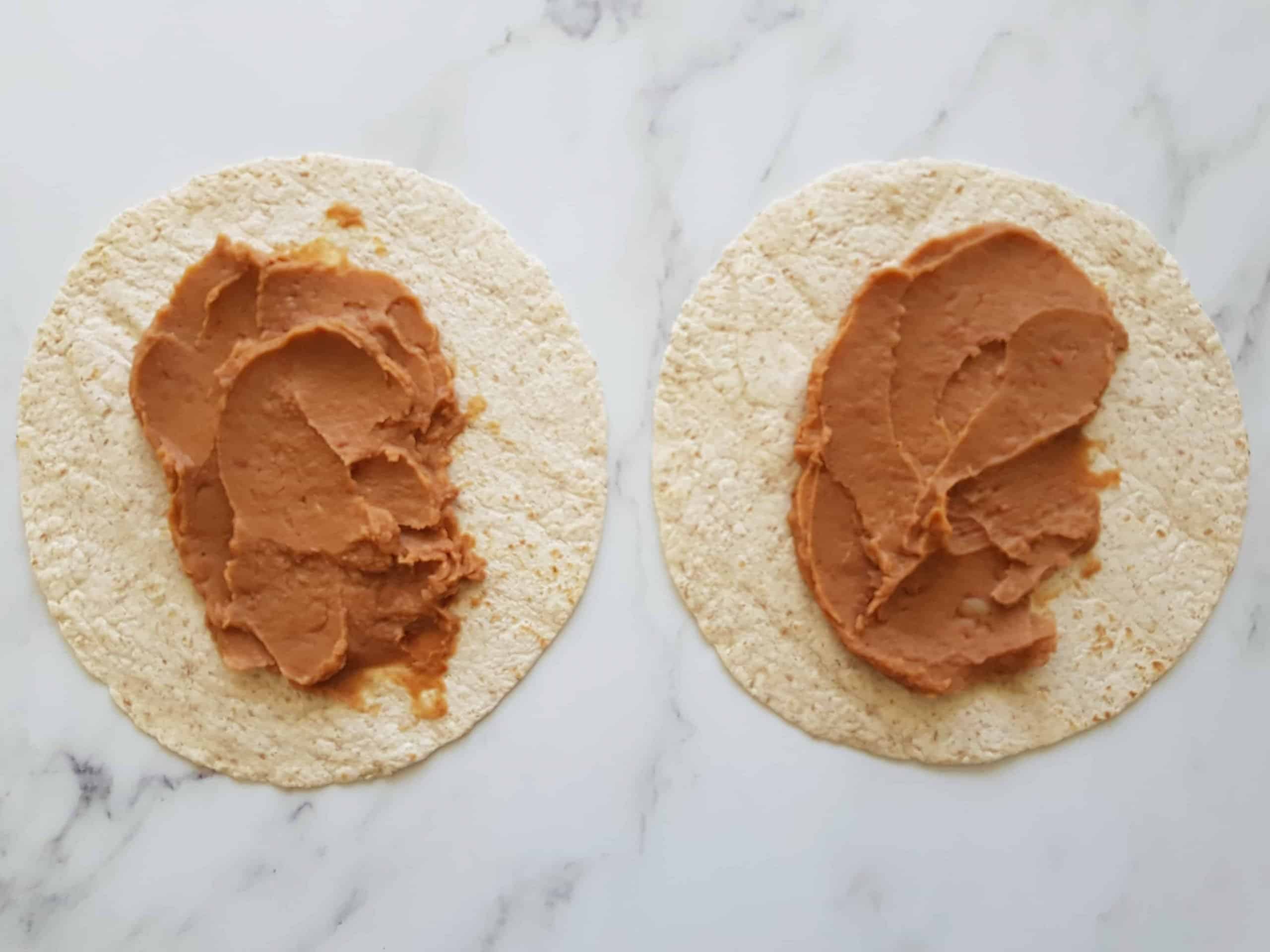 Tortilla wraps with refried beans on top.