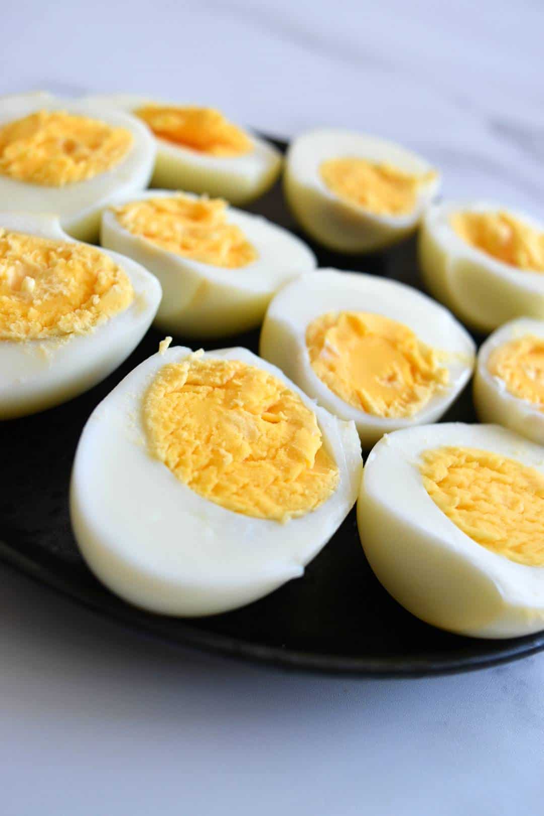 Hard boiled eggs cut in half on a plate.