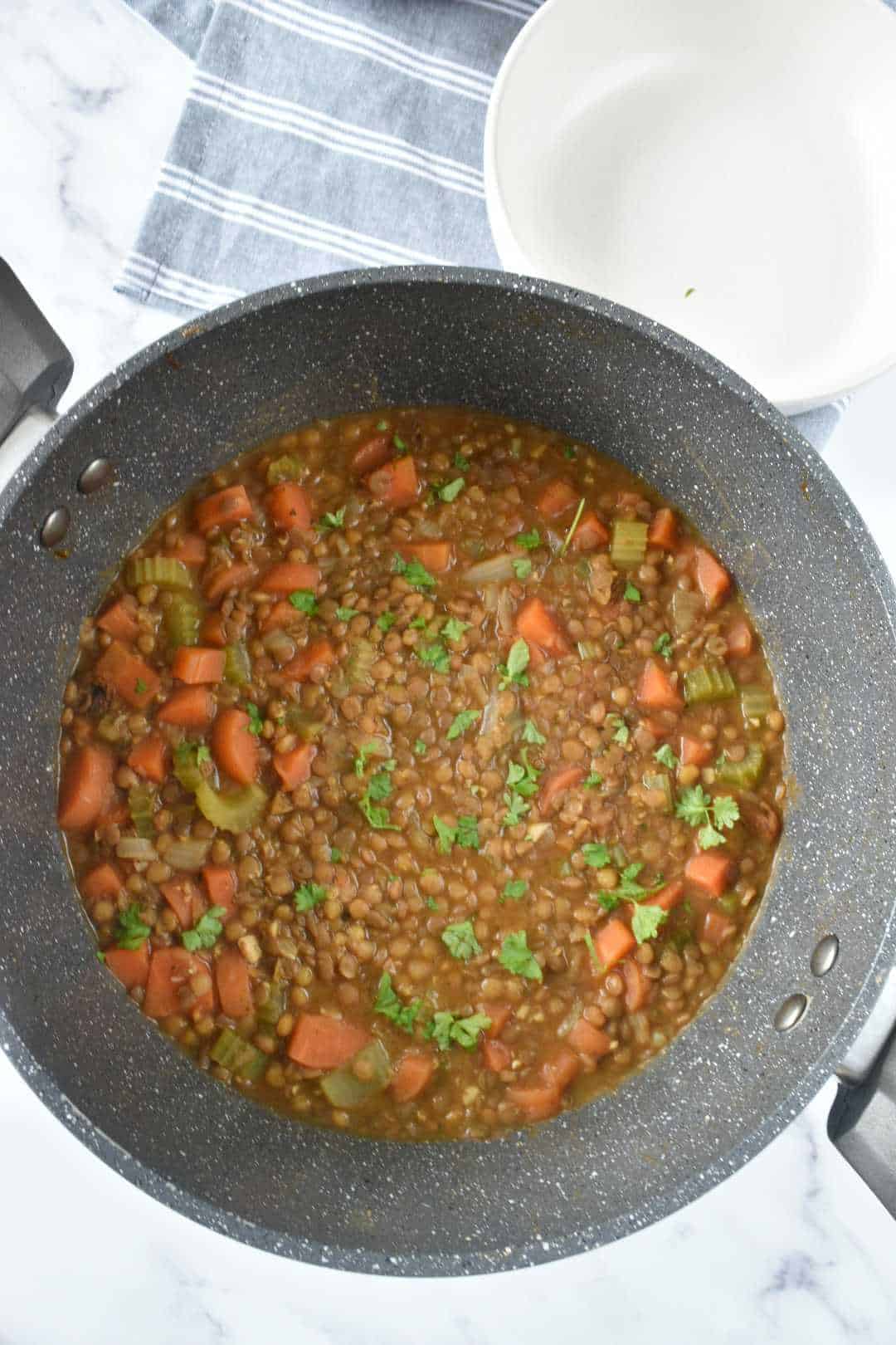 Bacon and lentil soup in a pot.