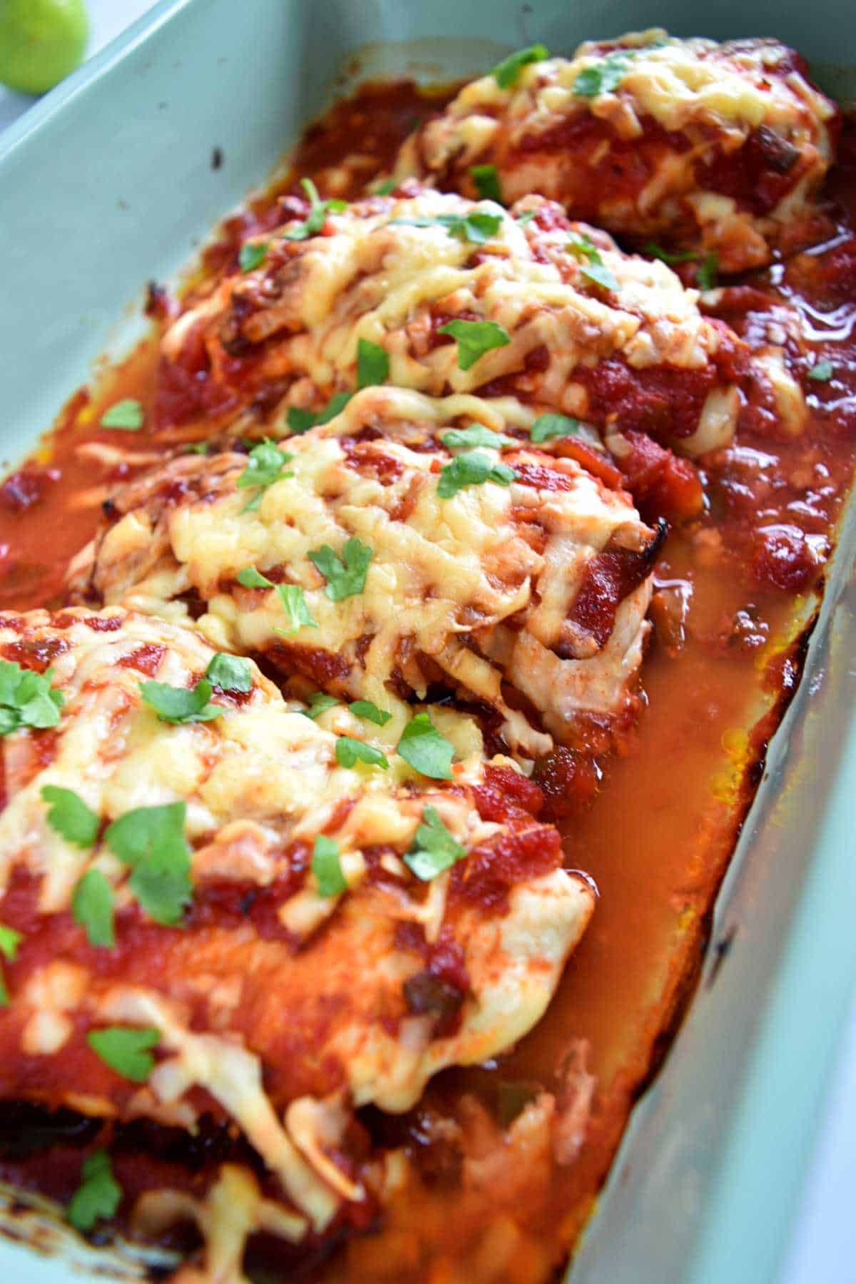 Baked chicken salsa with cheese in a casserole dish.