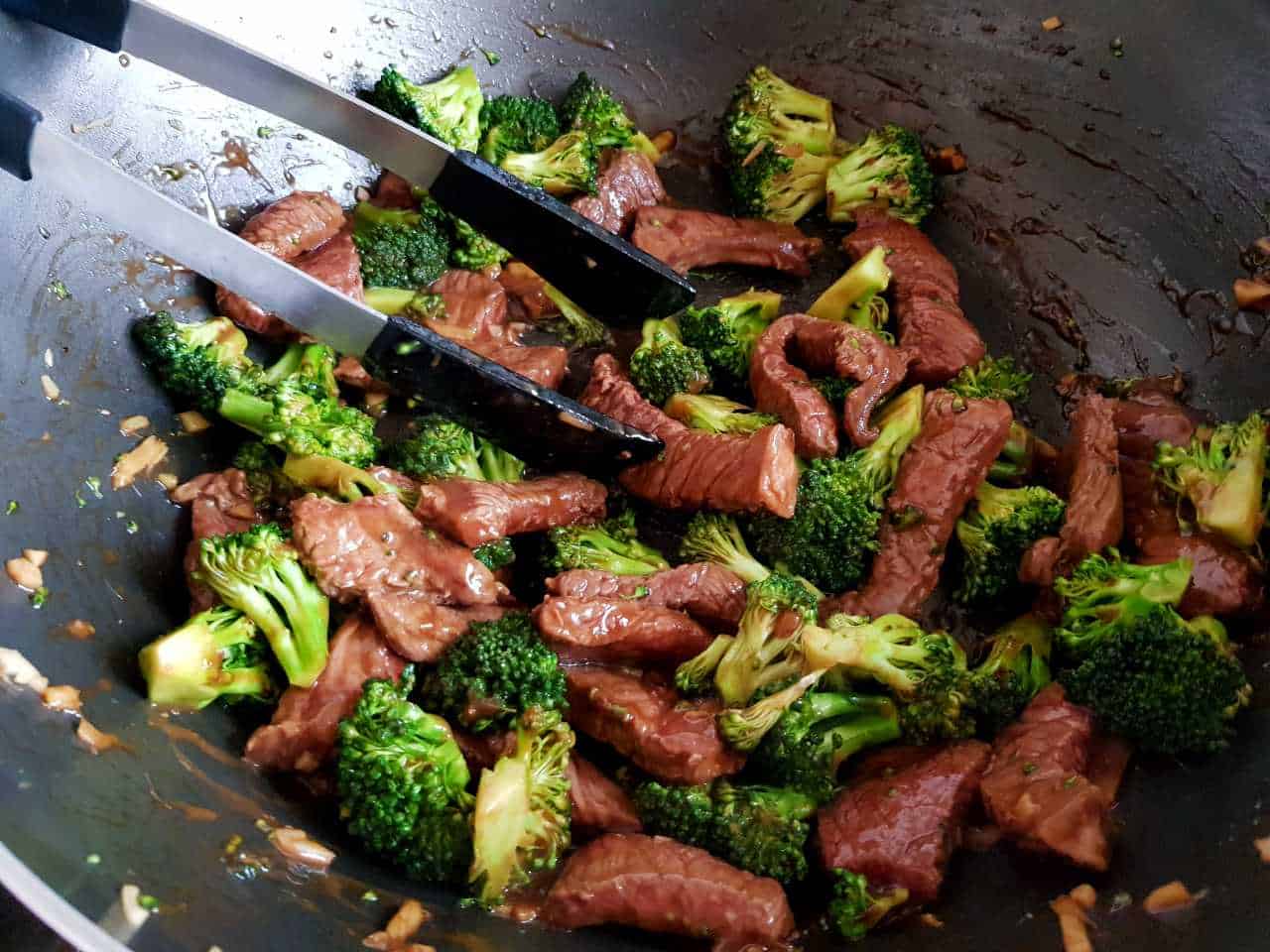 Broccoli and beef stir fry in a wok.