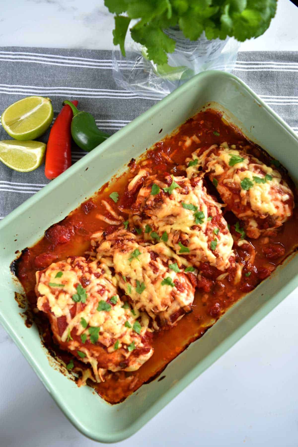 Baked salsa chicken in a casserole dish.