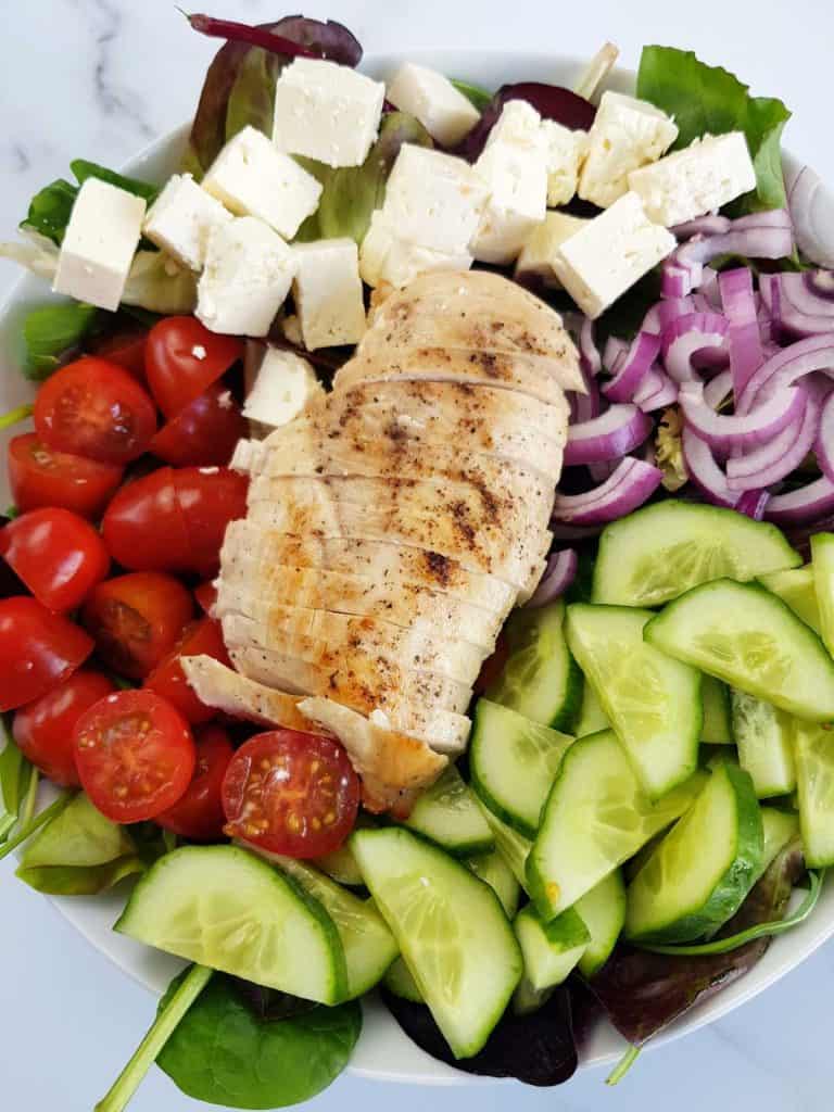 Greek chicken salad with feta, tomatoes, red onion and cucumbers.