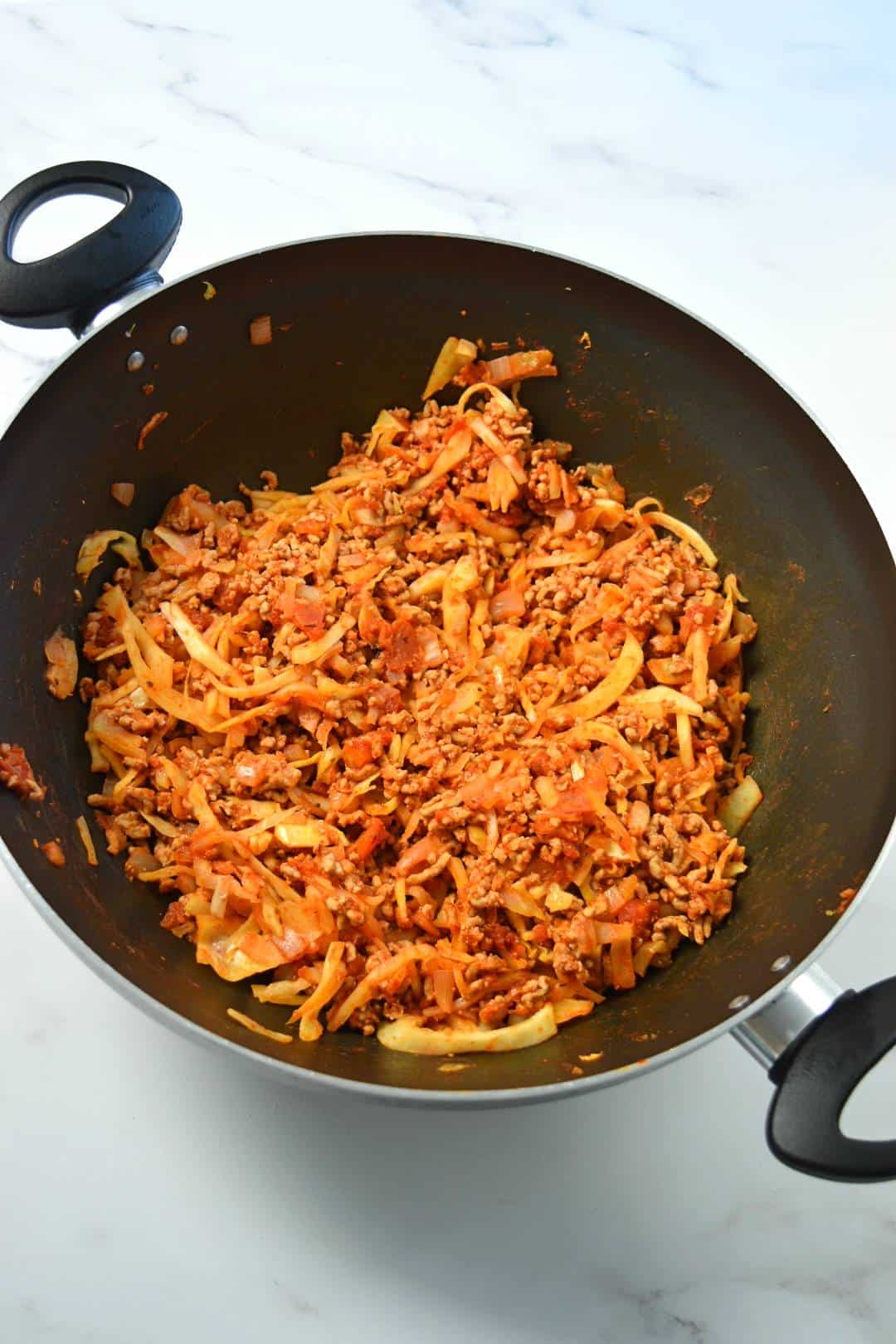 Ground beef and cabbage skillet on a marble table.