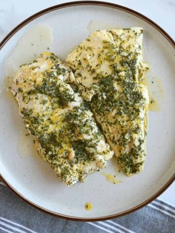 Lemon butter cod on a plate.