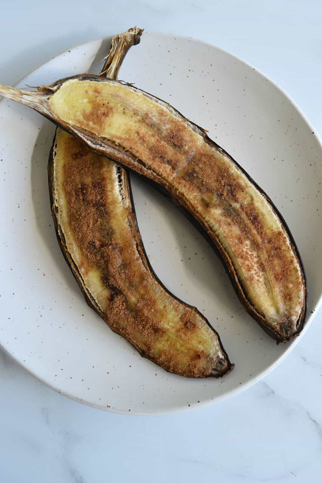 Oven baked bananas on a plate.