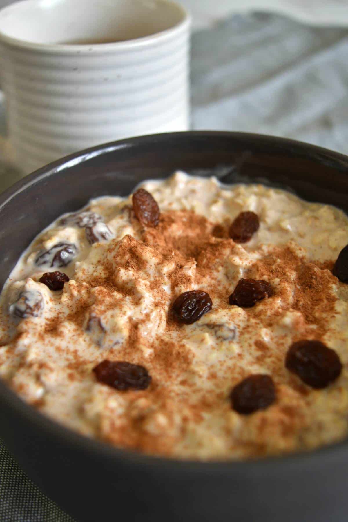 Overnight oats with cinnamon and raisins on a bowl.