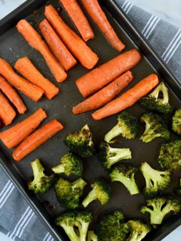 Roasted carrots and broccoli on a sheet pan.