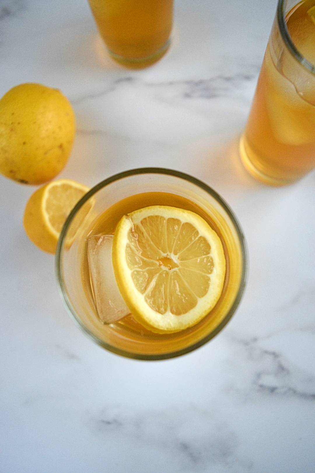 Iced tea in glasses served with lemon.