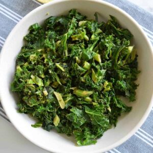 Stewed kale in a white bowl.