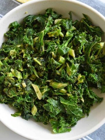 Stewed kale in a white bowl.