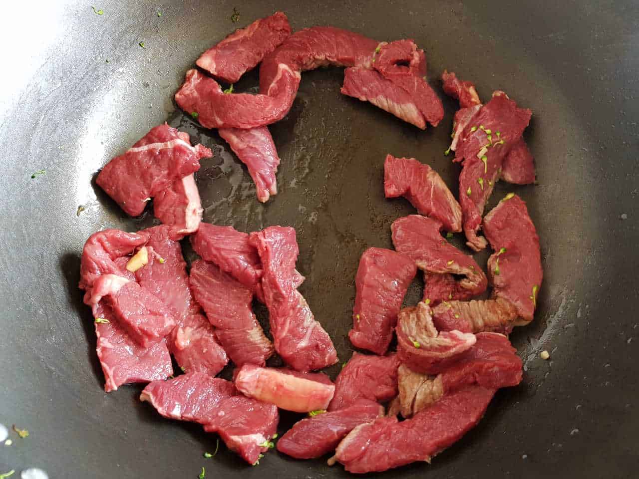 Beef strips in a wok.