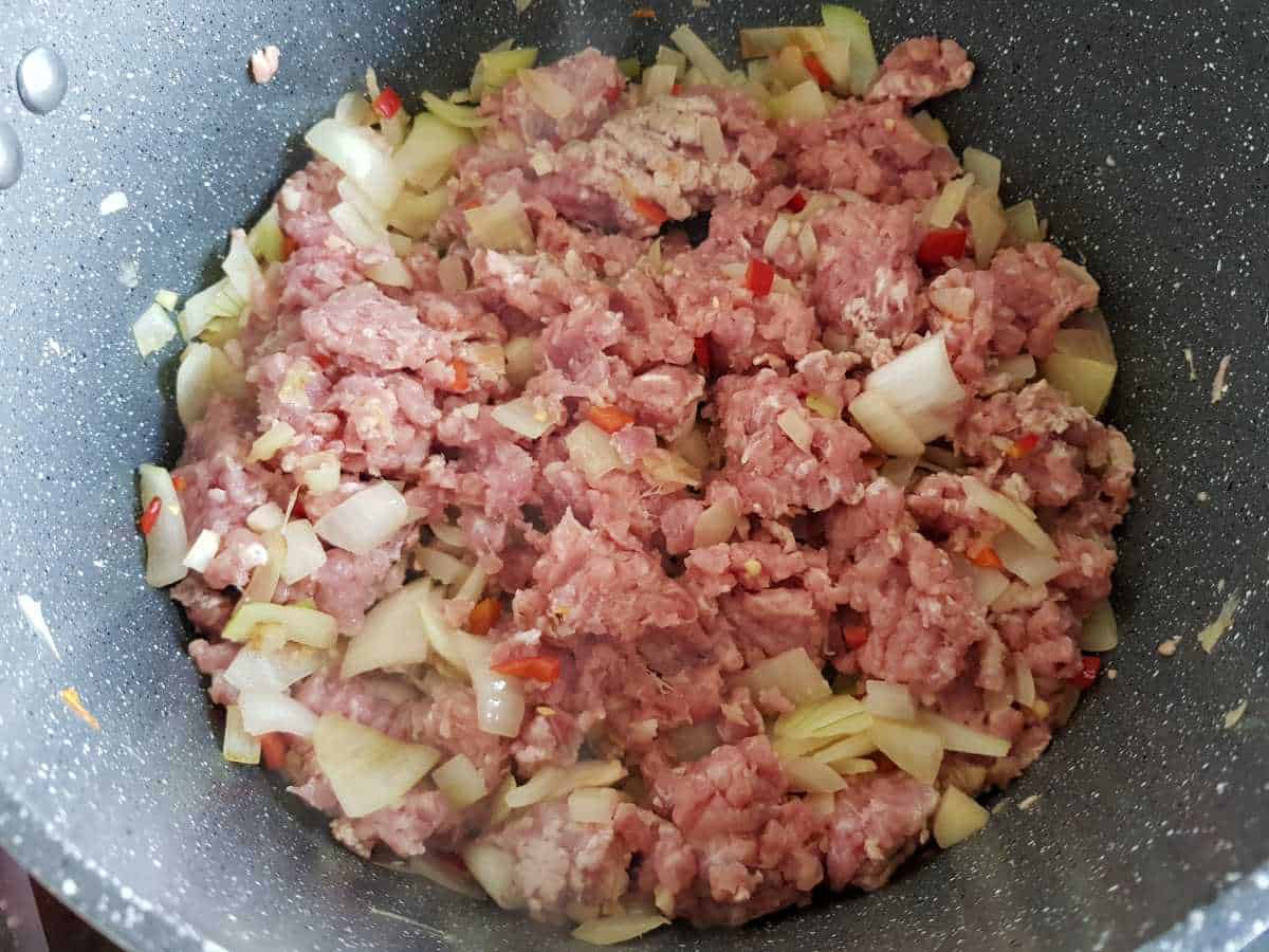 Onion, garlic, chili and ground turkey in a pot.