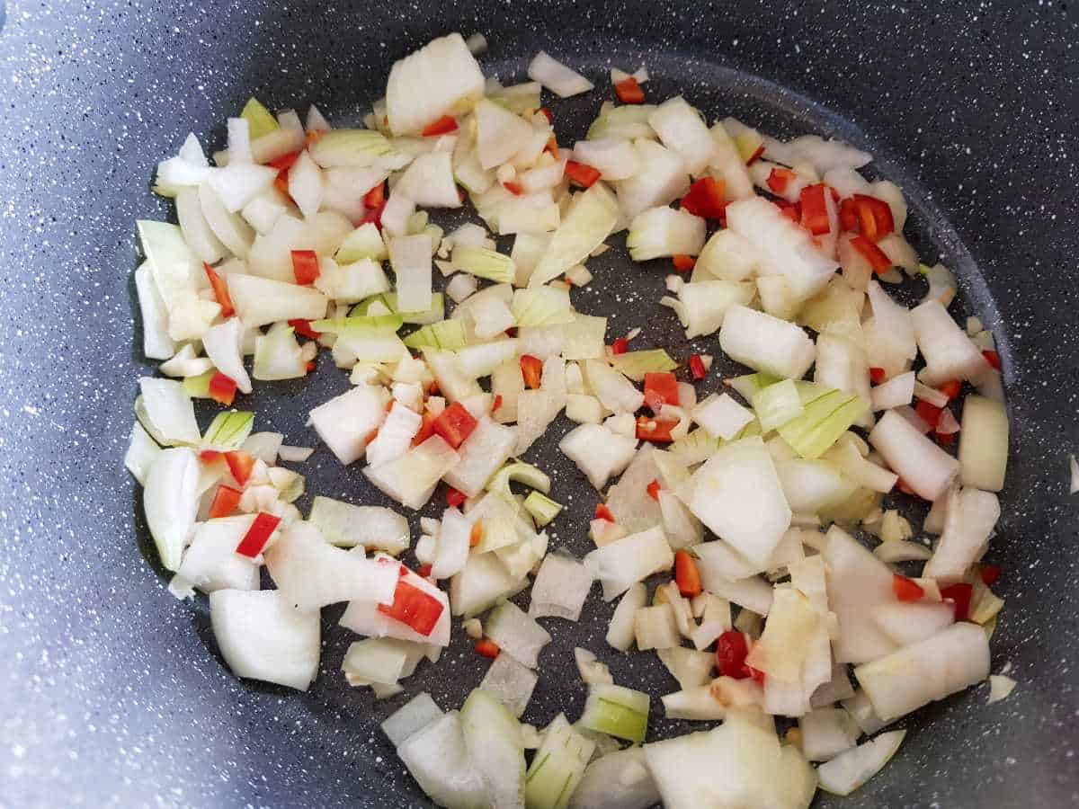 Onion and chili in a pot.