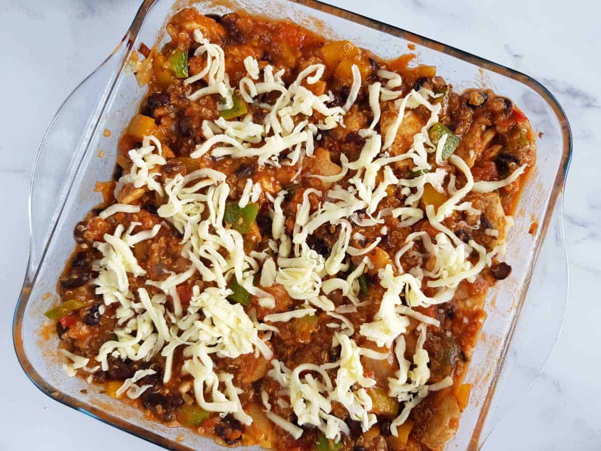 Unbaked Mexican quinoa casserole with cheese on top.