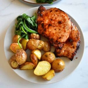 Air fryer pork chops with potatoes.